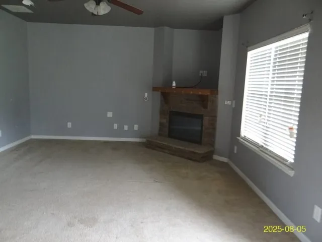 a view of empty room with a fireplace