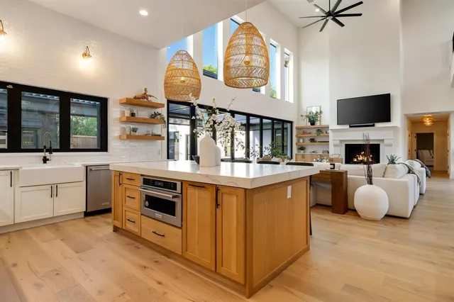 a large kitchen with stainless steel appliances granite countertop a stove and a sink