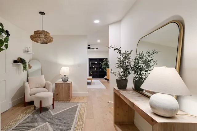 a living room with furniture potted plant and a chandelier