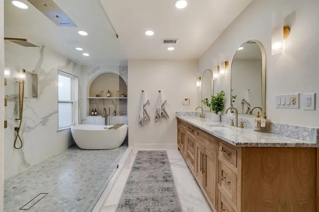 a large spacious bathroom with a granite countertop sink and a mirror