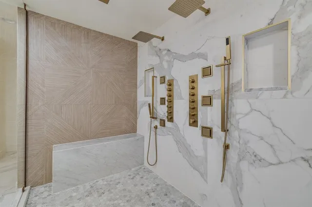 a bathroom with a granite countertop shower