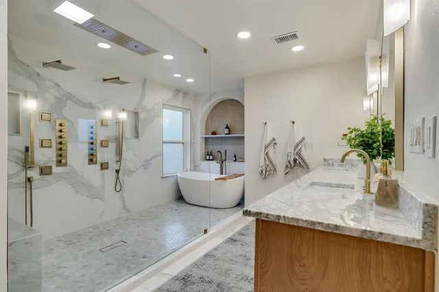 a view of a living room and kitchen with a tub