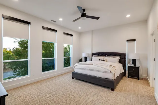 a bedroom with a large bed and a large window