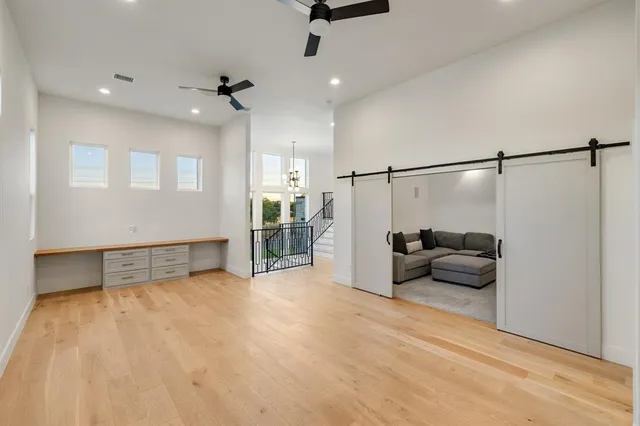 a living room with furniture and a ceiling fan