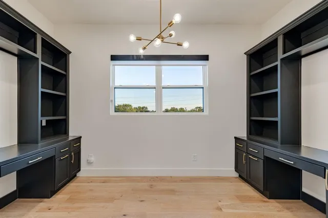 a view of wooden floor and windows in a room