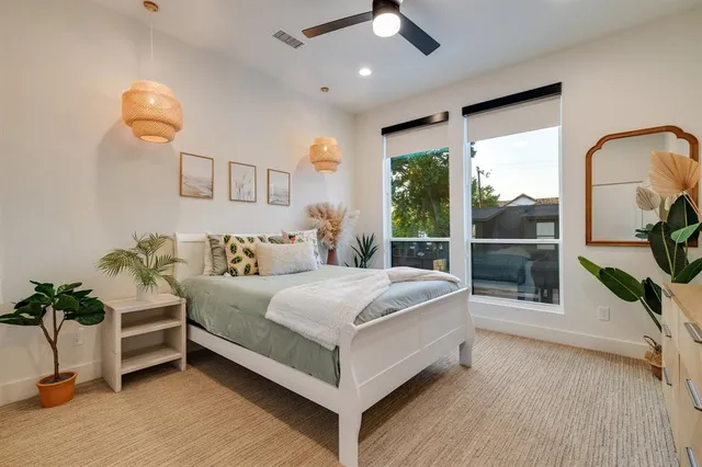 a bedroom with a large bed and a chandelier