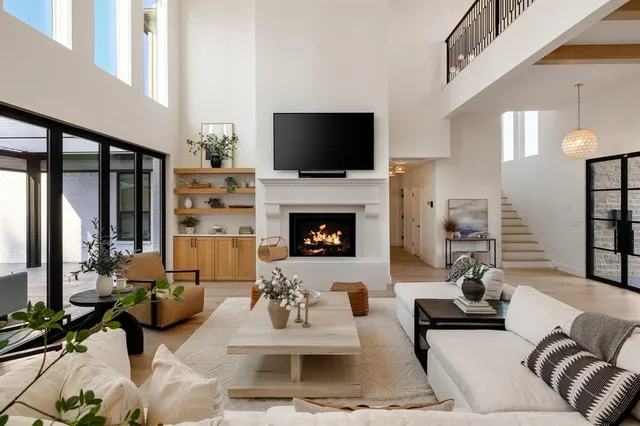 a living room with furniture a flat screen tv and a fireplace