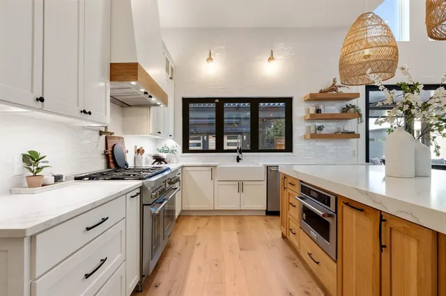 a kitchen with a sink stove and cabinets