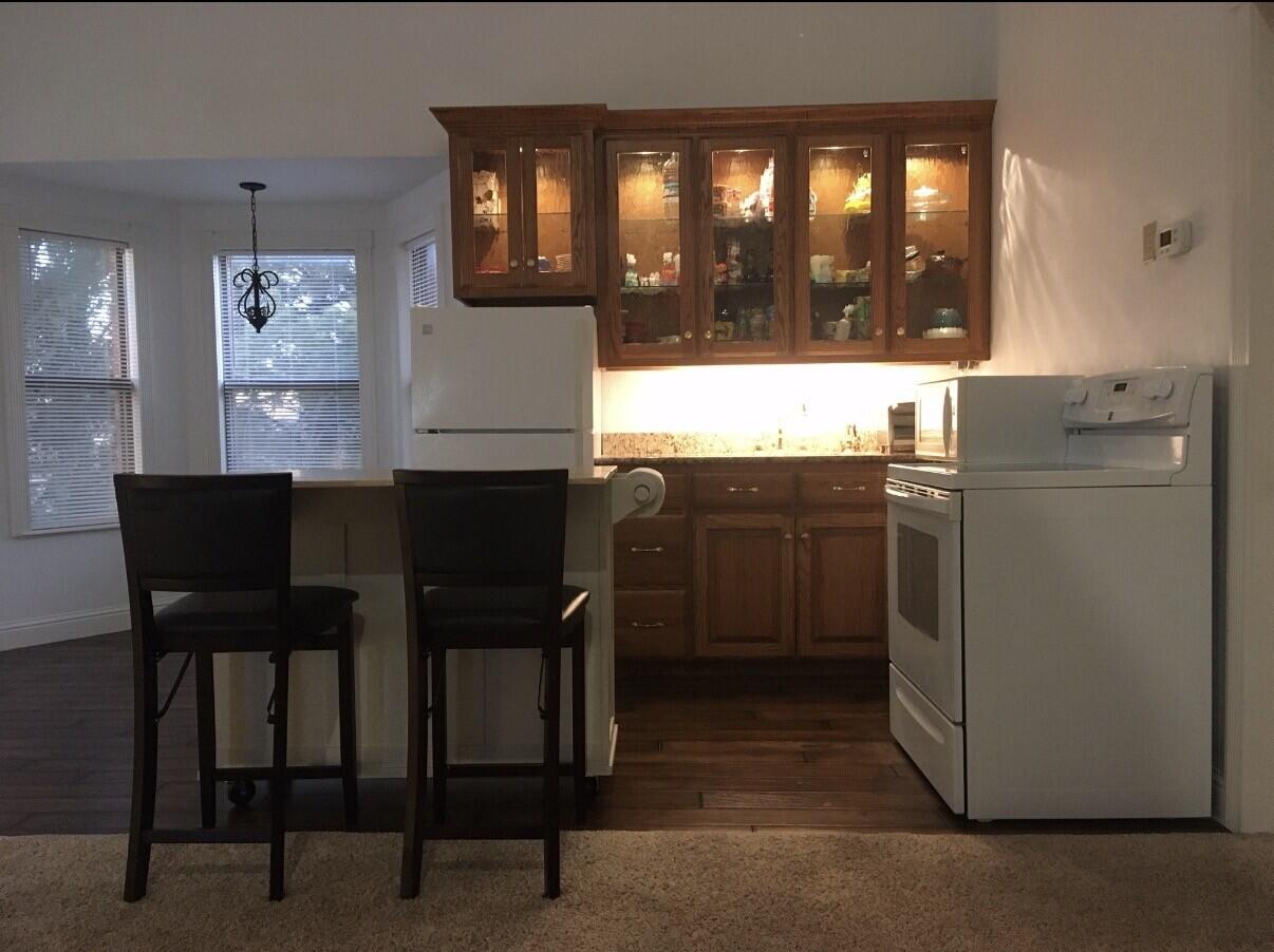 101 Southeast 6th Plainview, TX 79072 - Photo 15 of 31 a kitchen with a table chairs refrigerator and cabinets