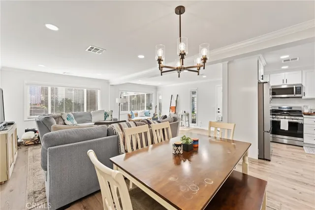 a living room with furniture wooden floor and a chandelier