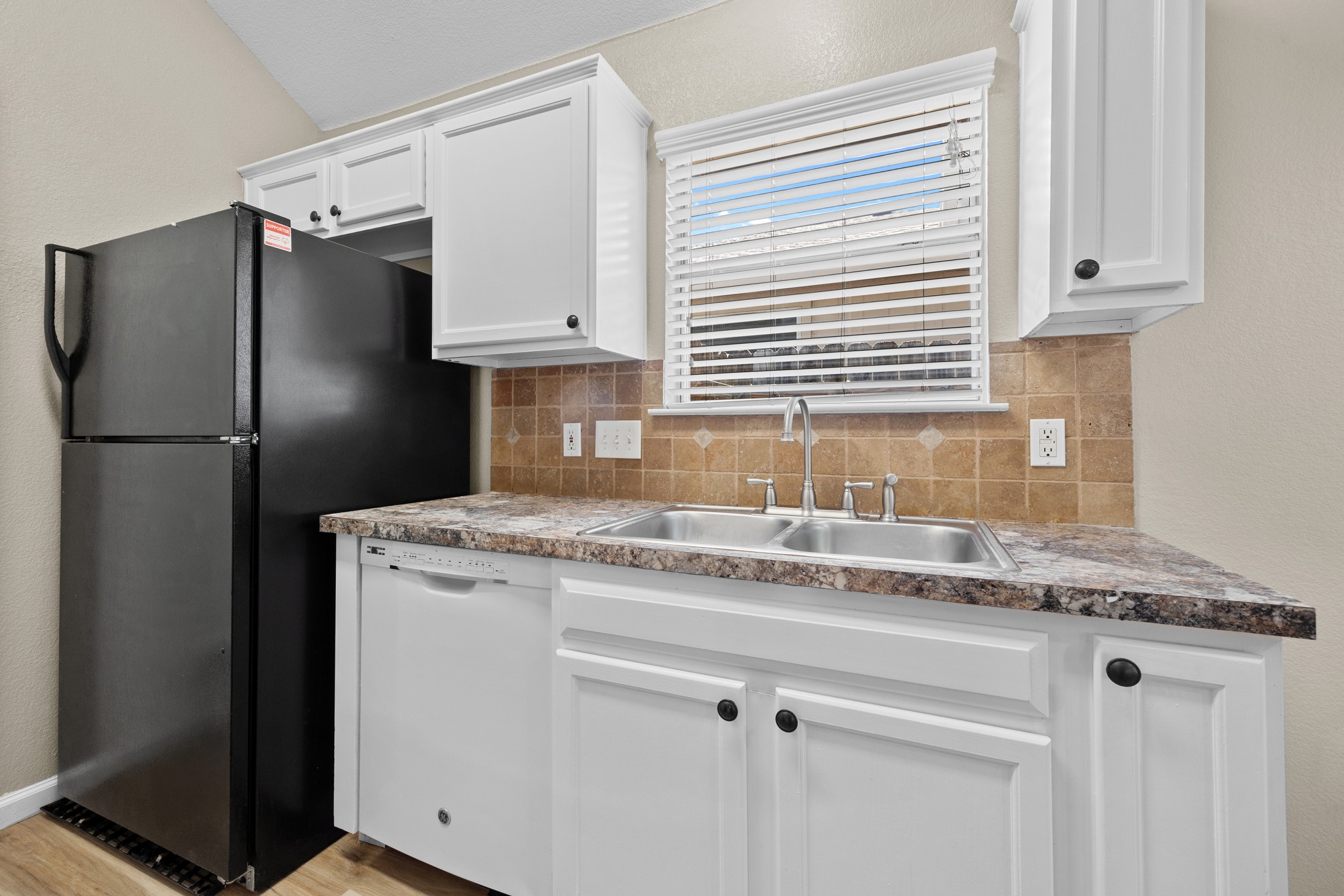 1806 Rusty Nail Loop Round Rock, TX 78681 - Photo 11 of 28 Functional kitchen offers ample cabinetry, a double sink, and convenient appliances for daily living.