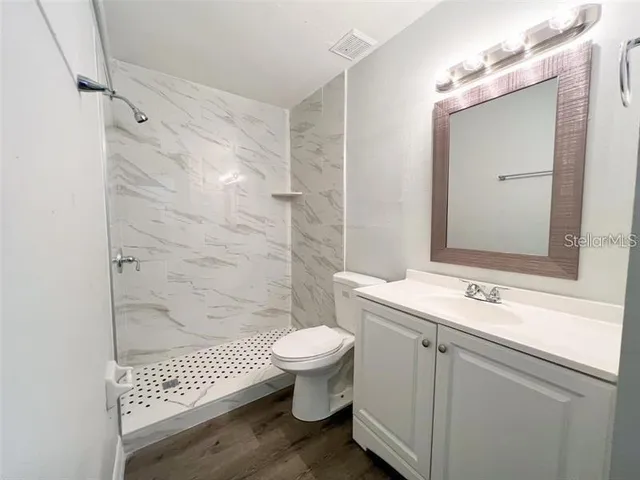 a bathroom with a sink toilet and shower