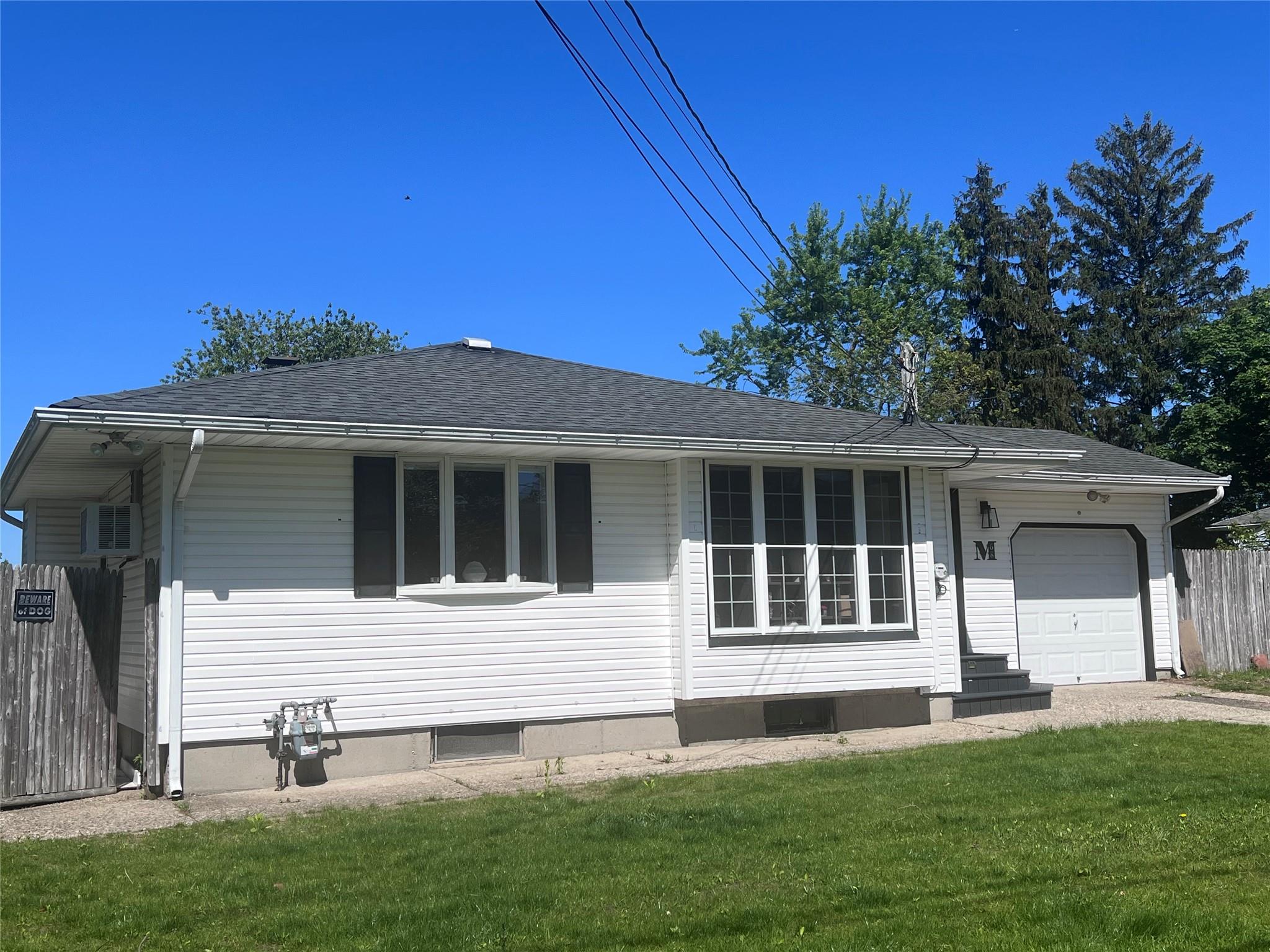 68 Ruland Road North Selden, NY 11784 - Photo 1 of 1 View of front of house featuring a garage, roof with shingles, and driveway