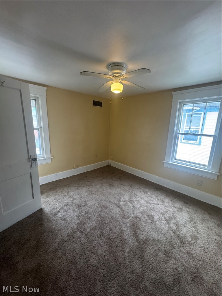 577 Rhodes Avenue Akron, OH 44307 - Photo 10 of 19 Carpeted empty room featuring plenty of natural light and ceiling fan