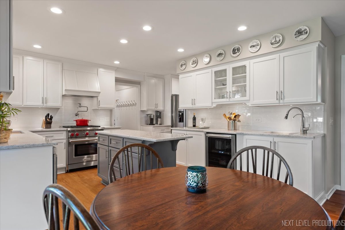 912 Turnbridge Circle Naperville, IL 60540 - Photo 11 of 34 a kitchen with a stove a sink a dining table and chairs