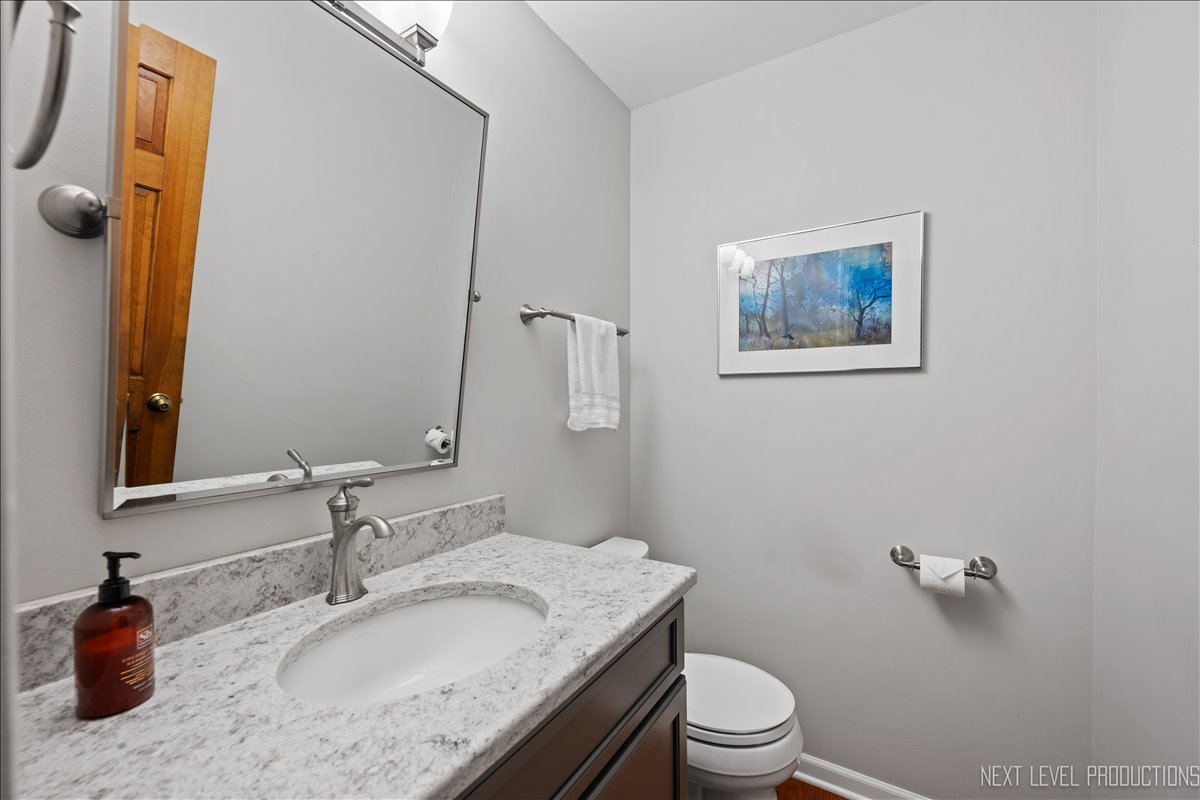912 Turnbridge Circle Naperville, IL 60540 - Photo 19 of 34 a bathroom with a granite countertop sink toilet and mirror