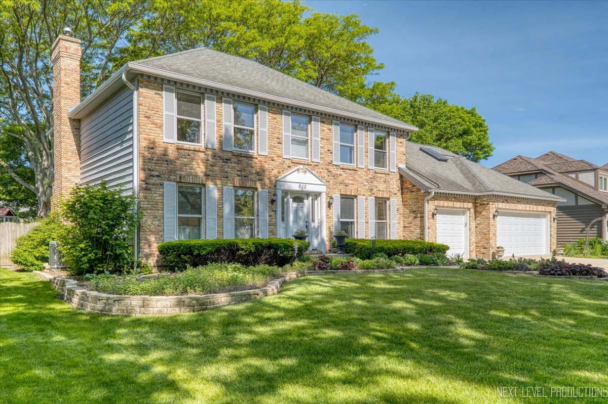 912 Turnbridge Circle Naperville, IL 60540 - Photo 2 of 34 a front view of a house with a yard