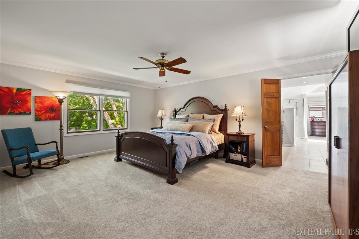 912 Turnbridge Circle Naperville, IL 60540 - Photo 21 of 34 a bedroom with a bed a couch and a window