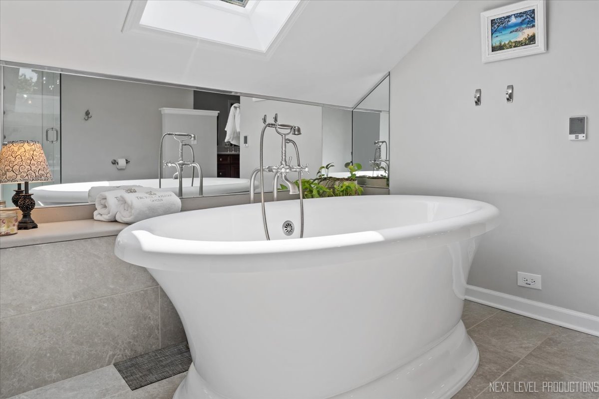 912 Turnbridge Circle Naperville, IL 60540 - Photo 25 of 34 a white bath tub sitting in a bathroom
