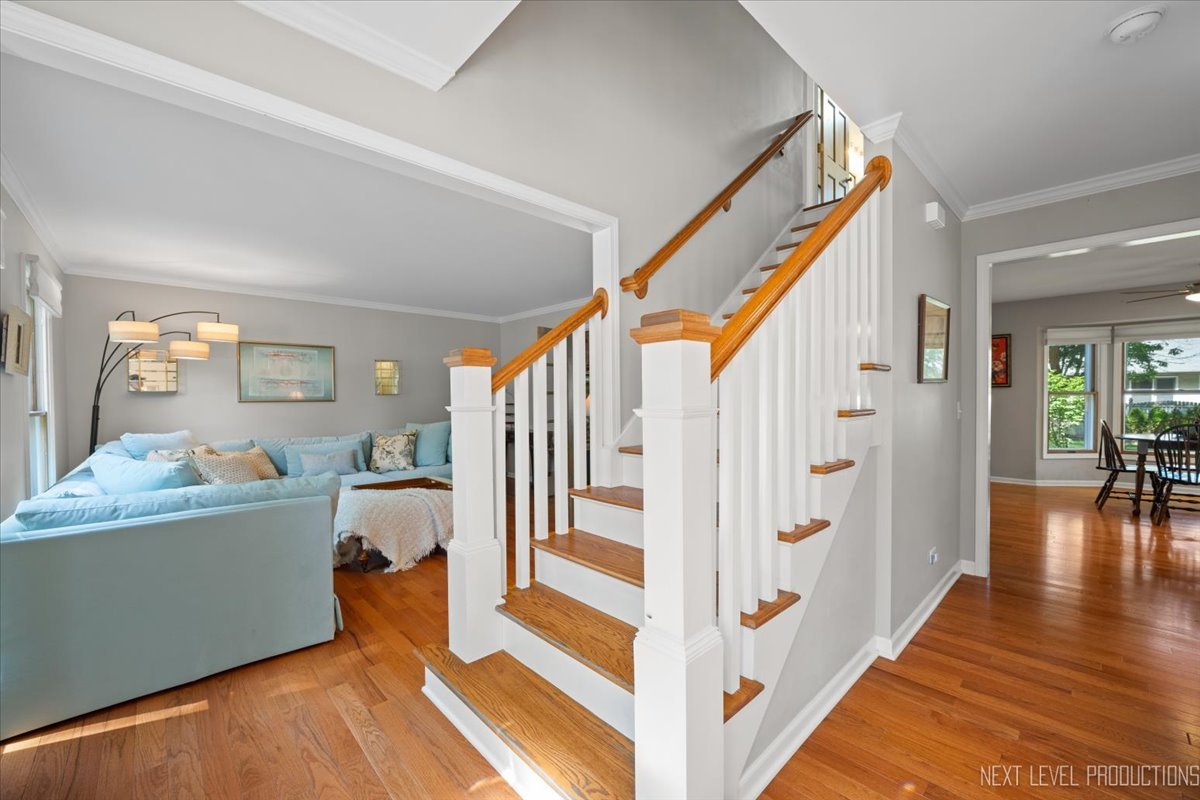 912 Turnbridge Circle Naperville, IL 60540 - Photo 5 of 34 a view of a hallway to a livingroom with wooden floor and furniture