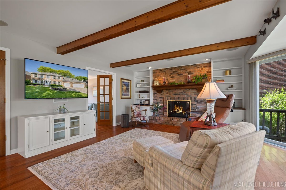 912 Turnbridge Circle Naperville, IL 60540 - Photo 10 of 34 a living room with furniture a flat screen tv and a fireplace