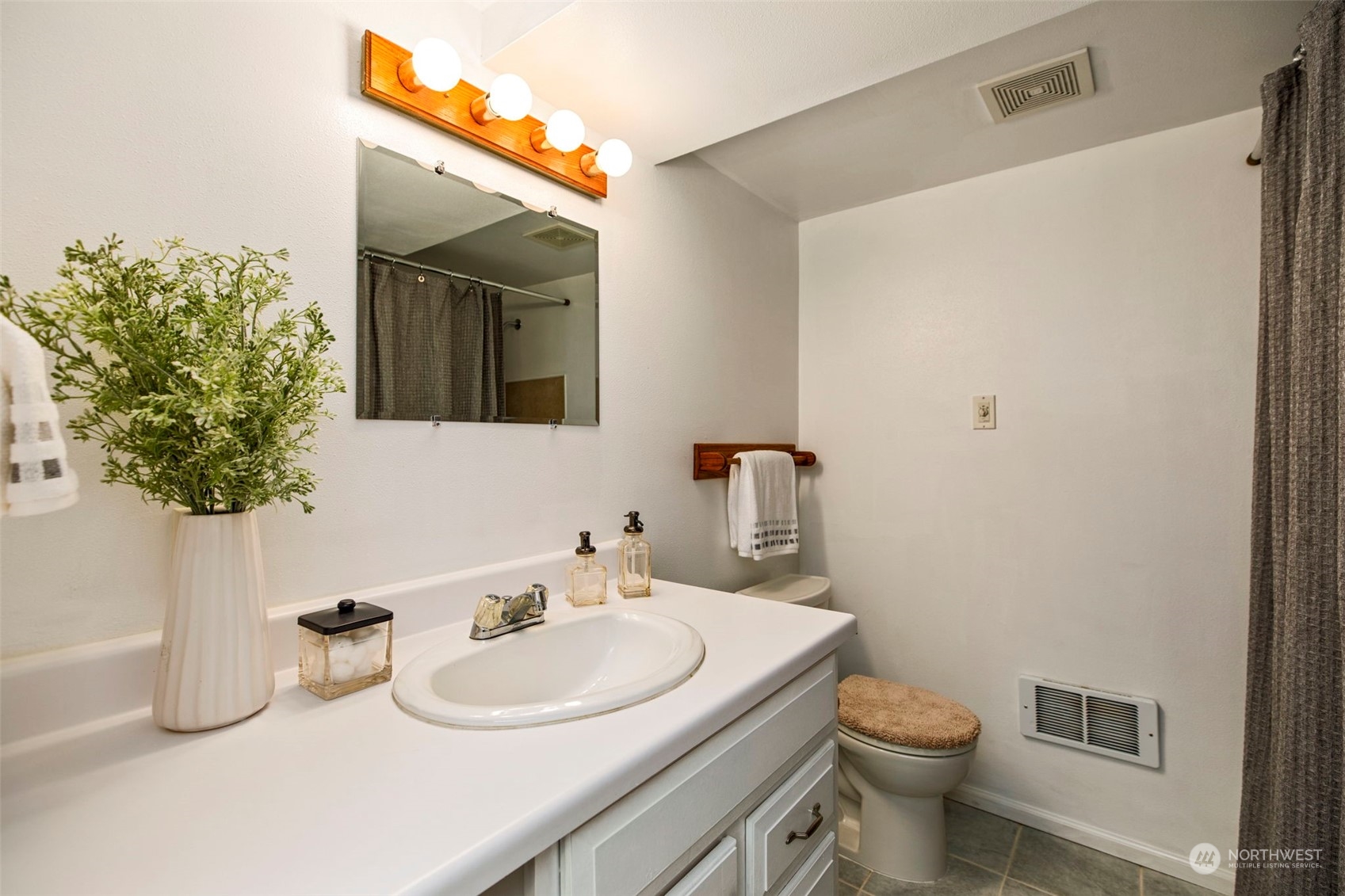 3416 Rockefeller Avenue Everett, WA 98201 - Photo 29 of 40 a bathroom with a toilet sink and mirror