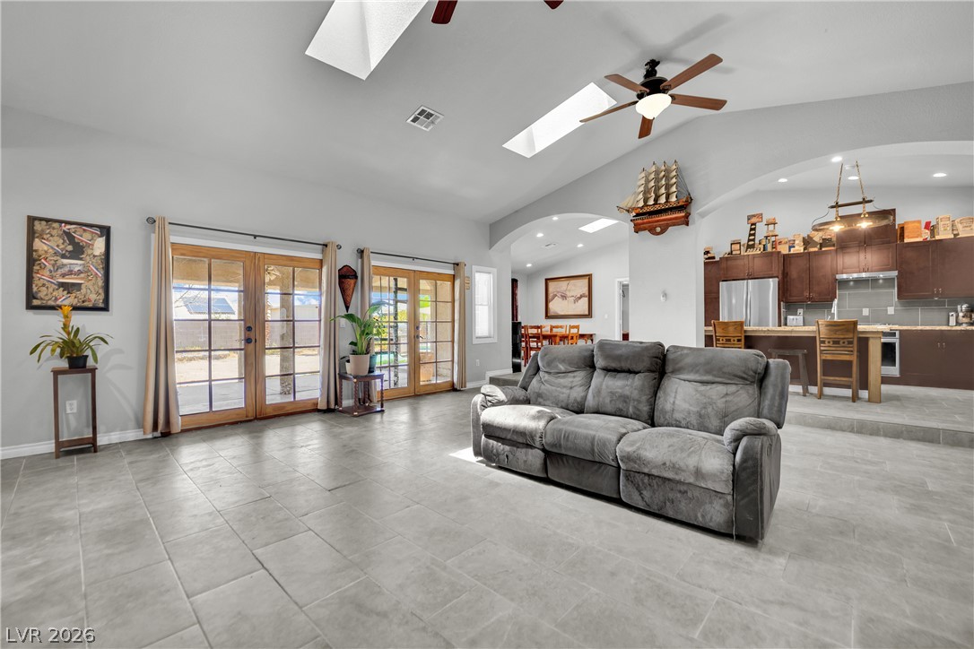 420 North Racetrack Road Henderson, NV 89015 - Photo 15 of 52 Natural light floods this living area, offering a seamless transition to the outdoors through multiple French doors.