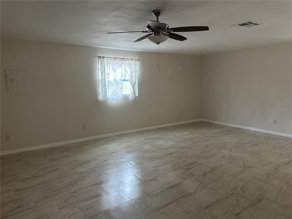 15921 Breakwater Lane Spring Hill, FL 34610 - Photo 14 of 26 an empty room with wooden floor and windows