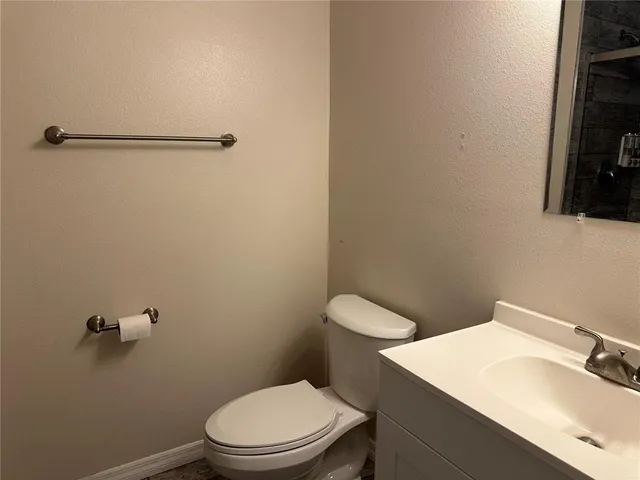 a white toilet sitting next to a bathroom sink
