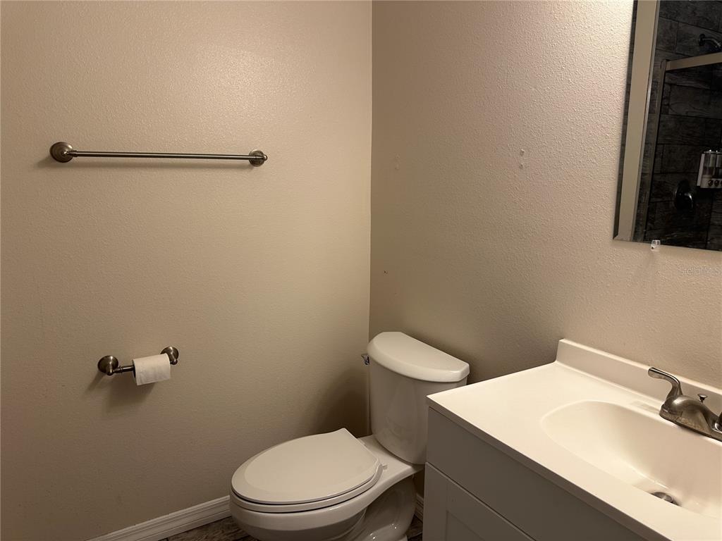 15921 Breakwater Lane Spring Hill, FL 34610 - Photo 15 of 26 a white toilet sitting next to a bathroom sink