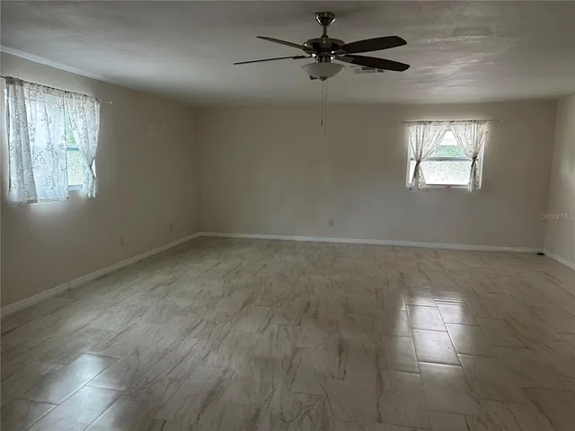 a view of empty room with windows
