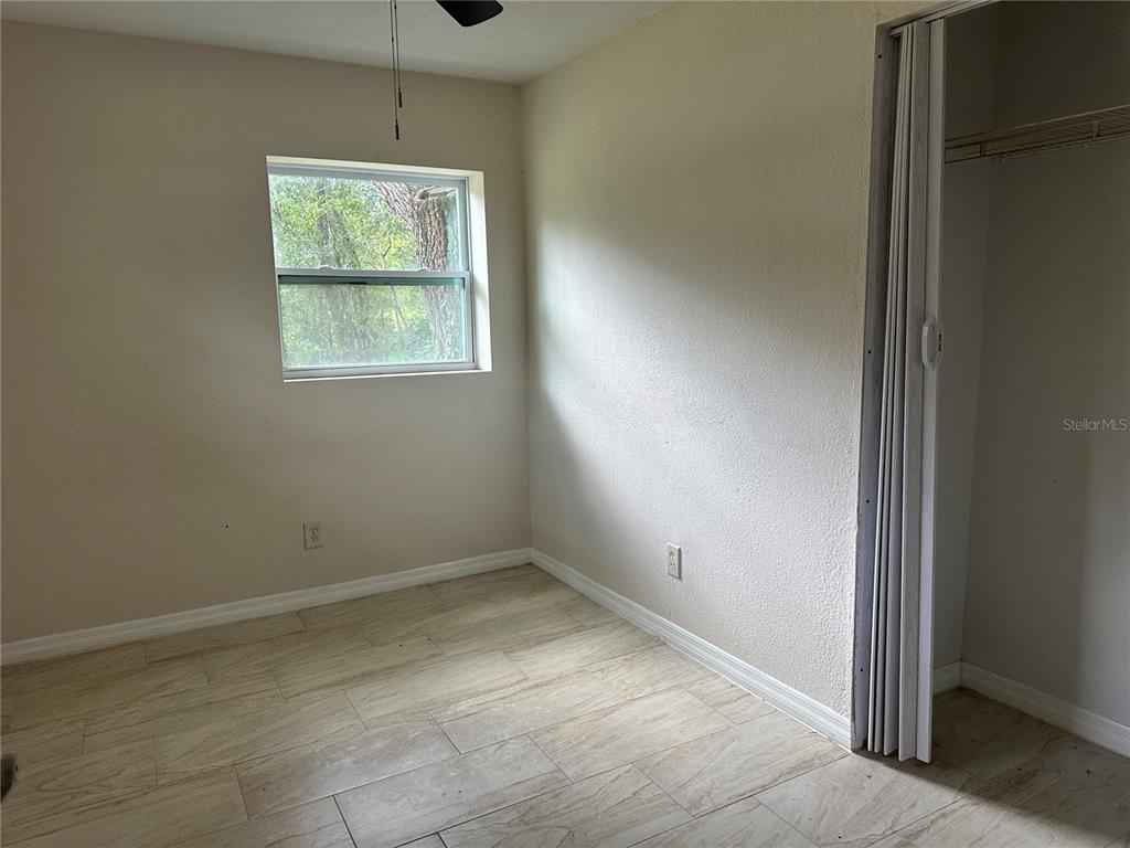 15921 Breakwater Lane Spring Hill, FL 34610 - Photo 19 of 26 an empty room with windows and closet