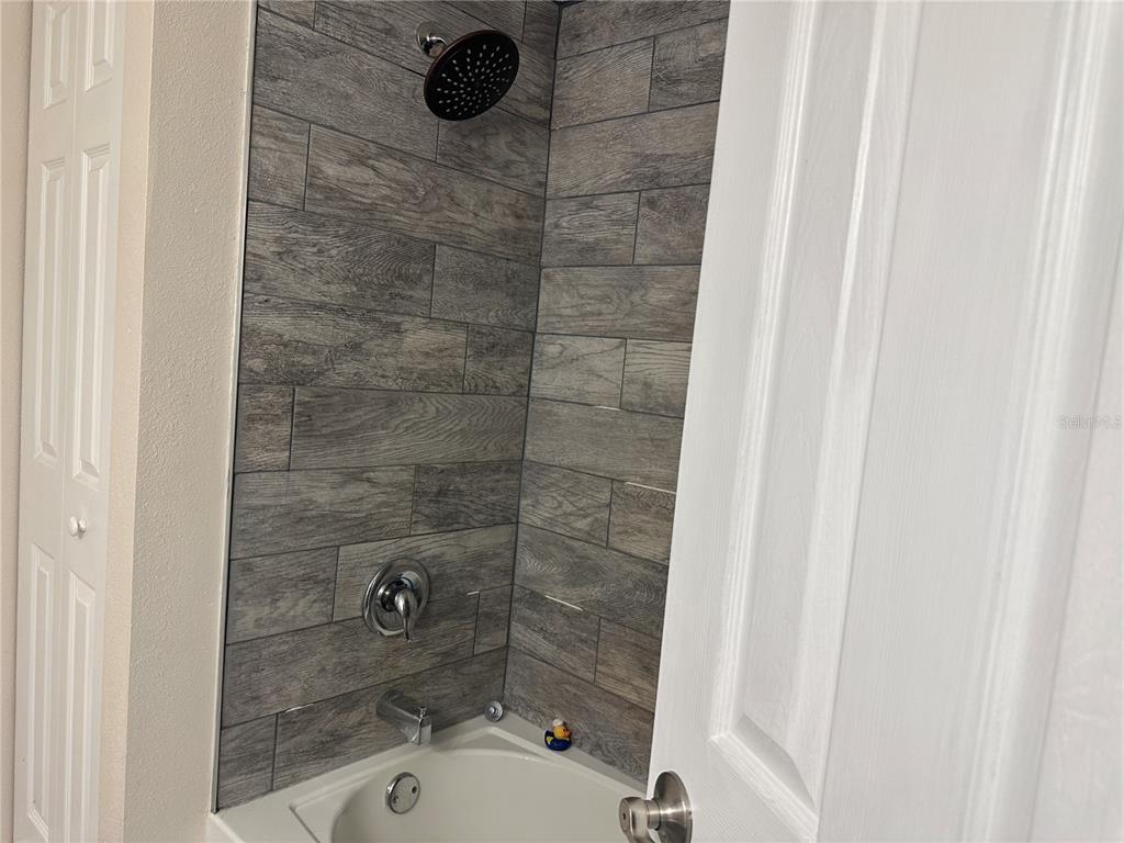 15921 Breakwater Lane Spring Hill, FL 34610 - Photo 21 of 26 a bathroom with a shower and a sink