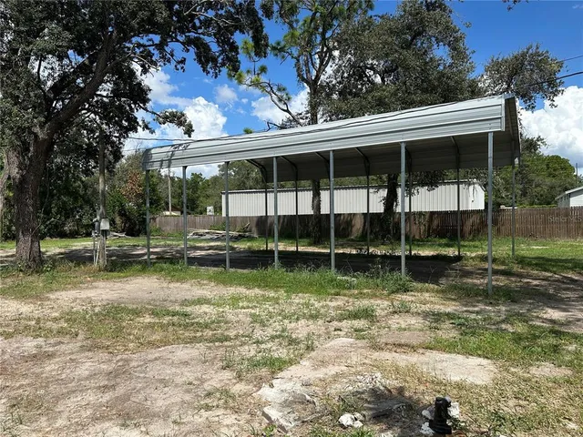 a view of a backyard with large trees