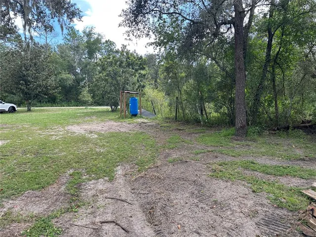 a backyard of a house with lots of green space