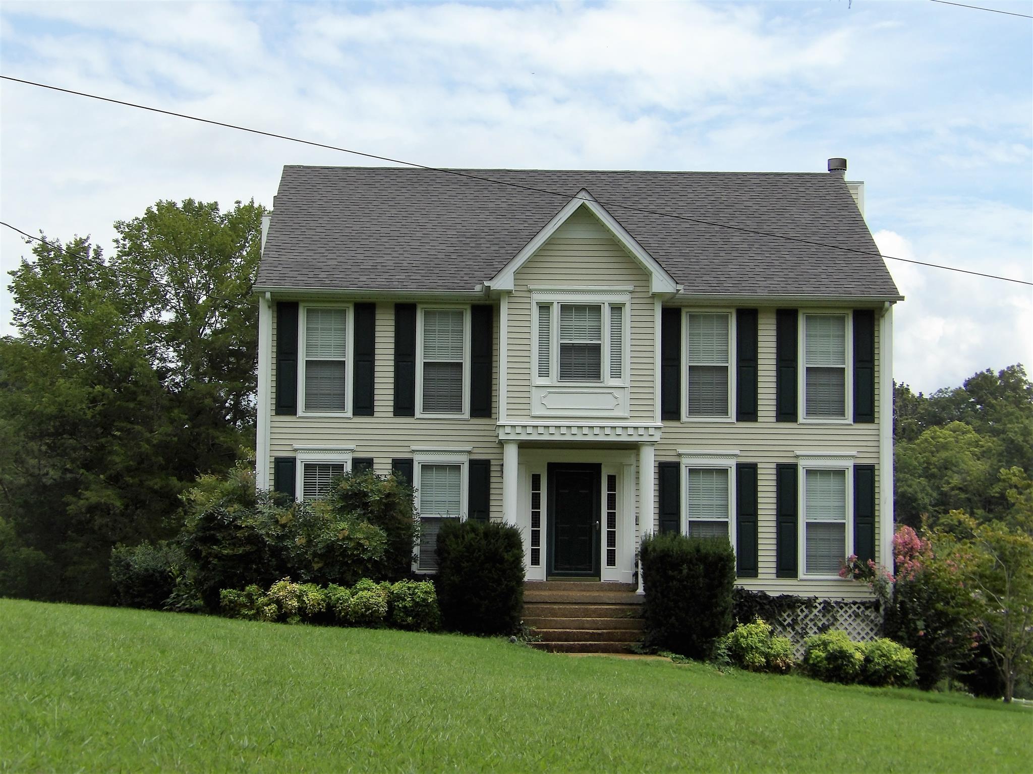 a front view of a house with a yard