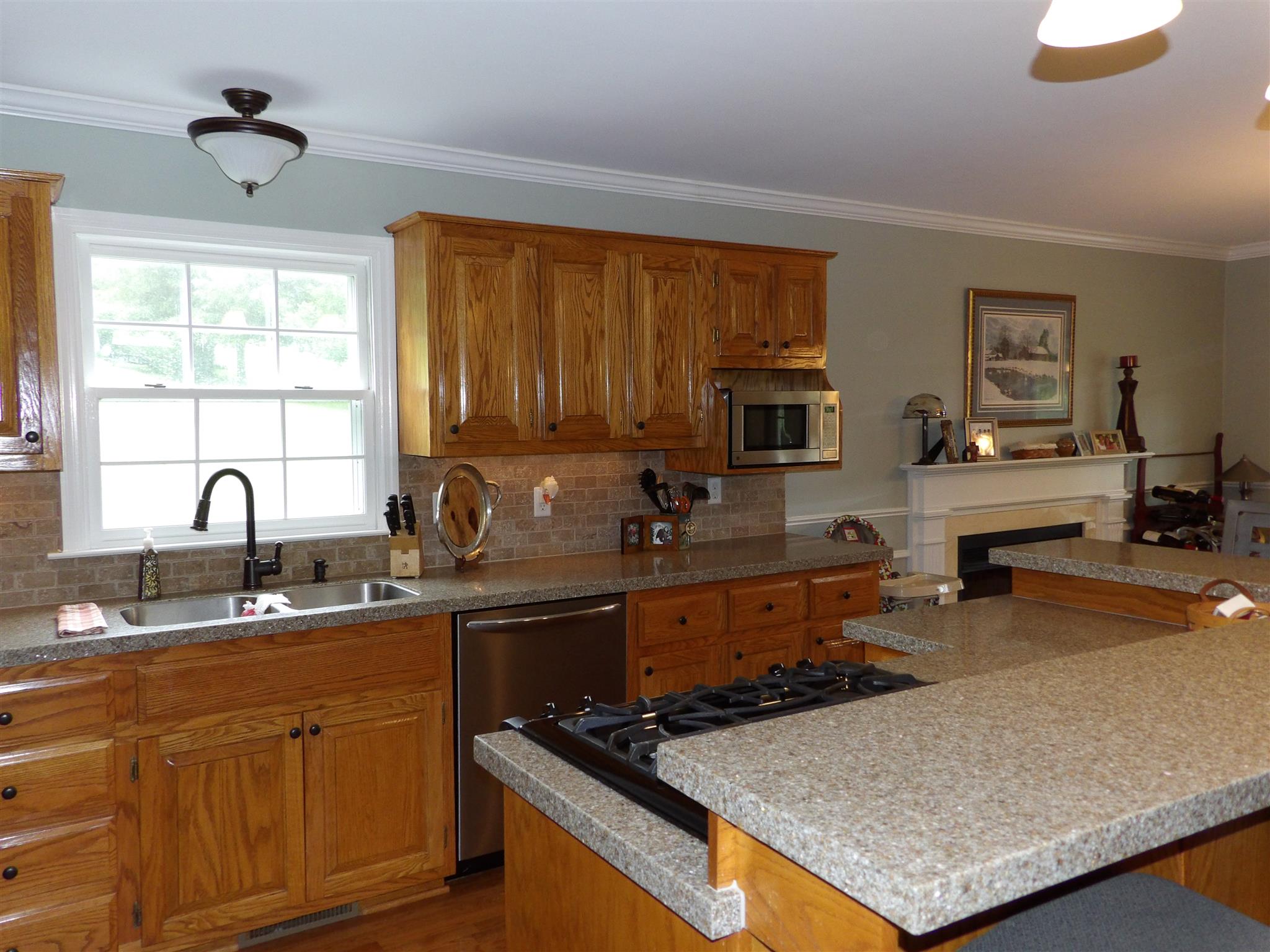 197 Spicer Road Burns, TN 37029 - Photo 13 of 28 a kitchen with stainless steel appliances granite countertop a sink stove and cabinets