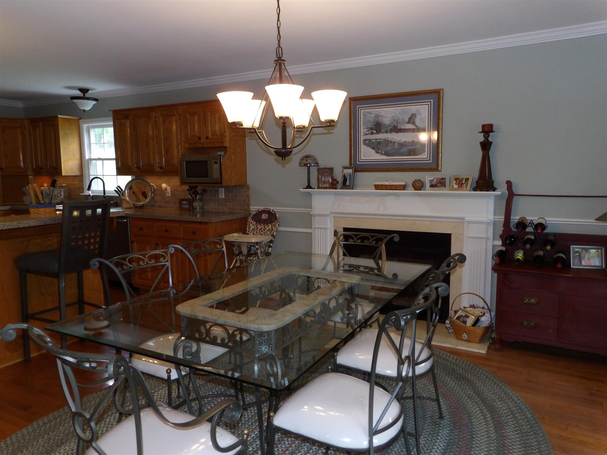 197 Spicer Road Burns, TN 37029 - Photo 14 of 28 a kitchen with a table chairs refrigerator and cabinets