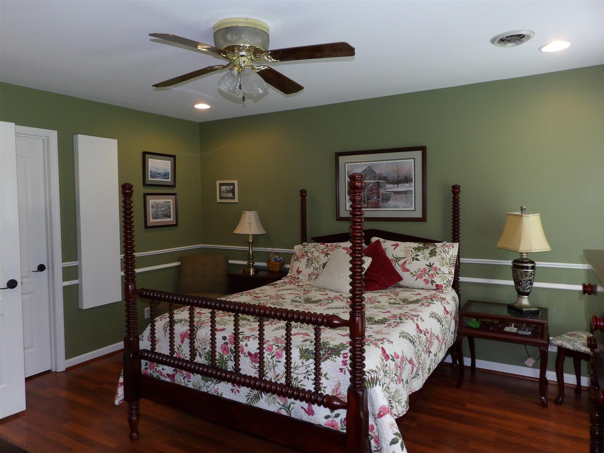 197 Spicer Road Burns, TN 37029 - Photo 17 of 28 a bed room with a bed and a chandelier