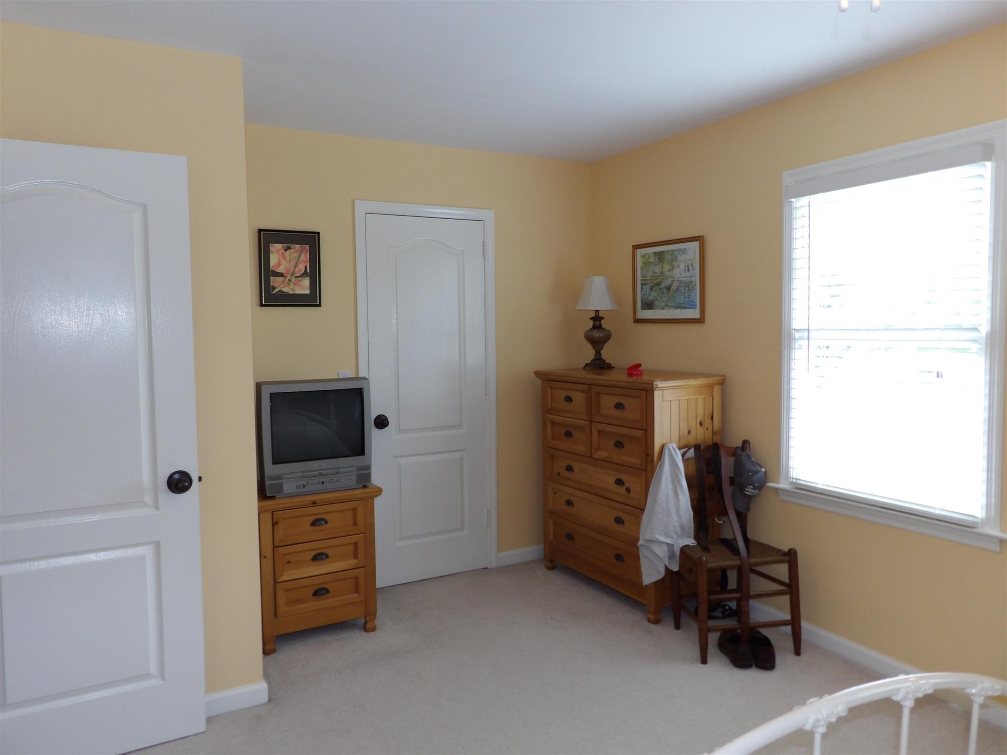 197 Spicer Road Burns, TN 37029 - Photo 21 of 28 a view of a bedroom with baby crib and a window