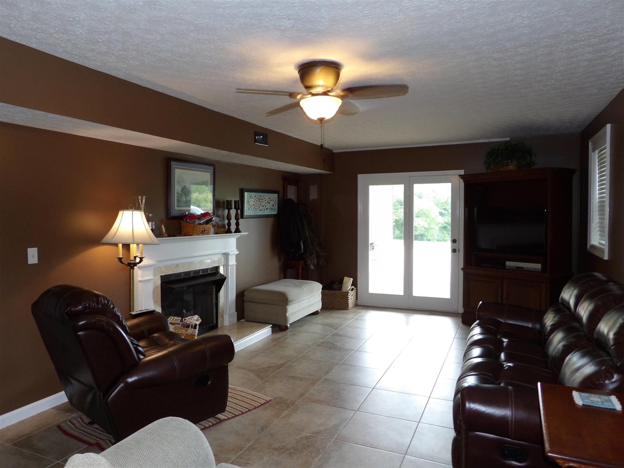 197 Spicer Road Burns, TN 37029 - Photo 27 of 28 a living room with furniture a flat screen tv and a fireplace
