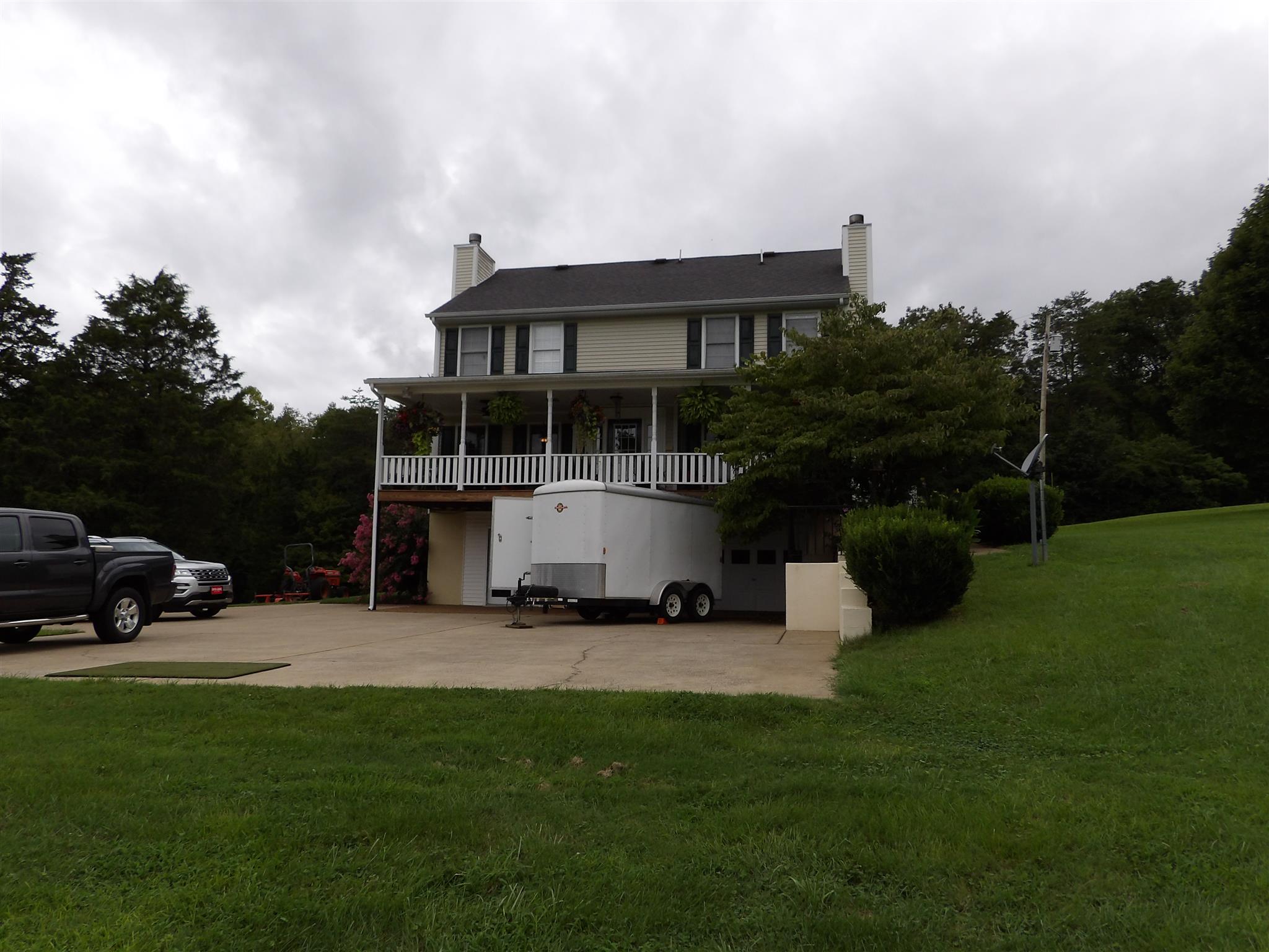 197 Spicer Road Burns, TN 37029 - Photo 3 of 28 a view of a house with backyard sitting area and garden