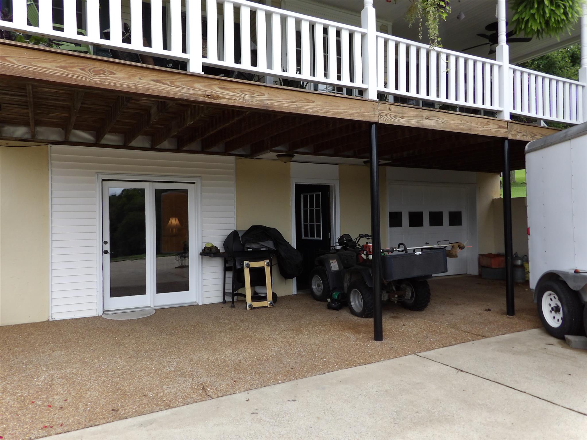 197 Spicer Road Burns, TN 37029 - Photo 4 of 28 a view of a patio with table and chairs and a barbeque