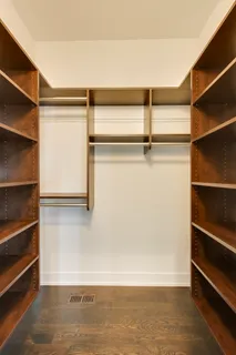 a view of walk in closet with empty racks