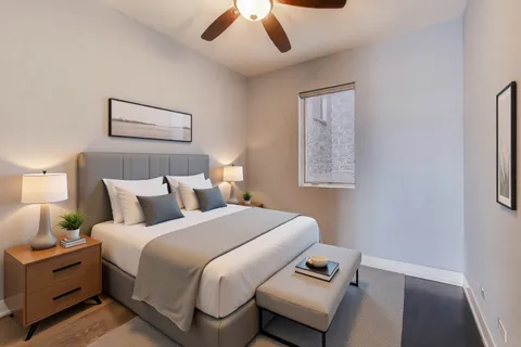 a bed room with a bed and a window