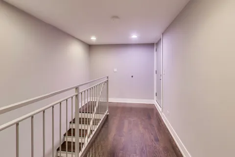a view of hallway with wooden floor