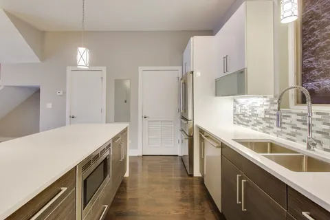 a kitchen with a sink and a refrigerator
