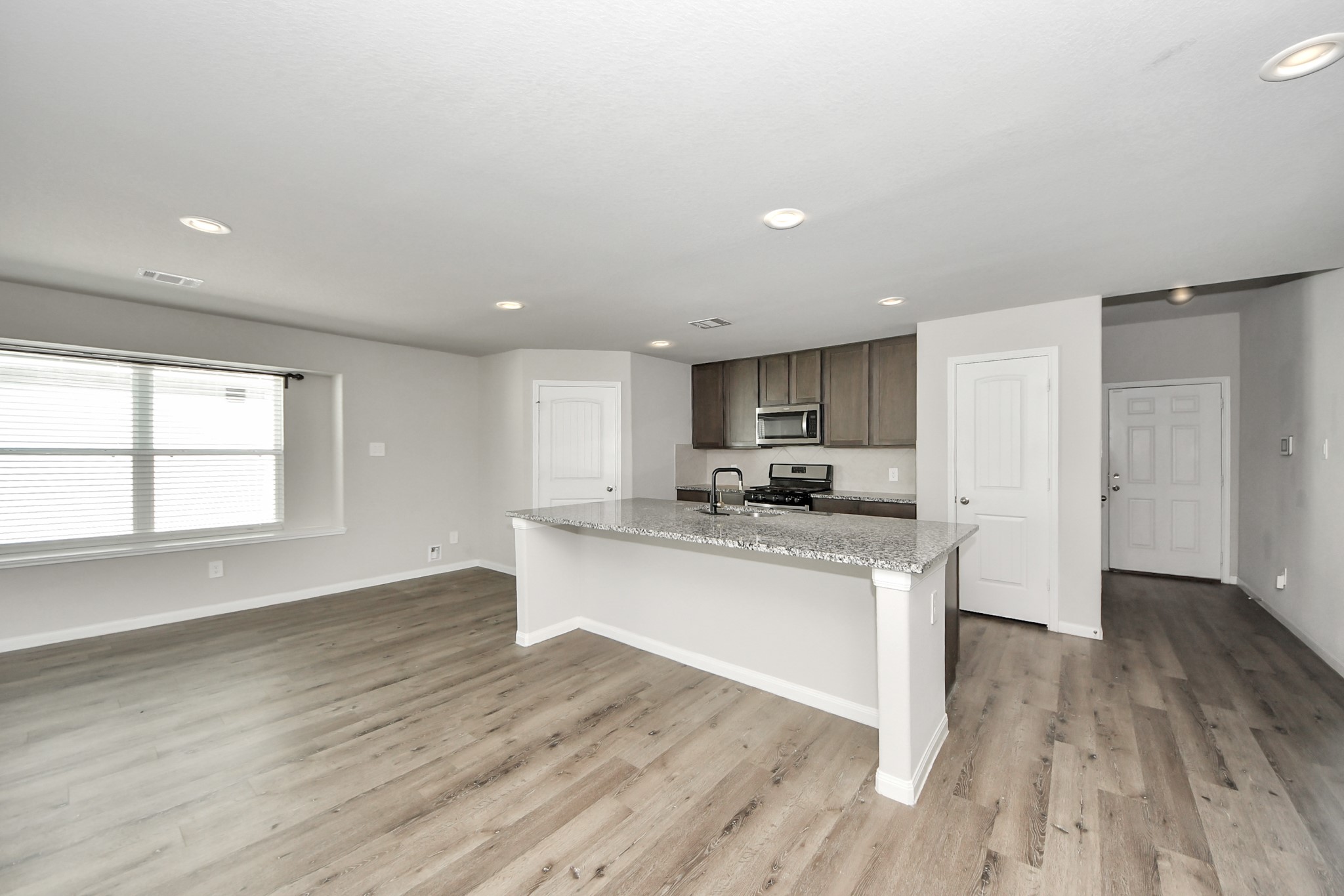 5626 Brooklyn Rose Drive Rosharon, TX 77583 - Photo 13 of 34 a kitchen with stainless steel appliances granite countertop a sink cabinets and wooden floor