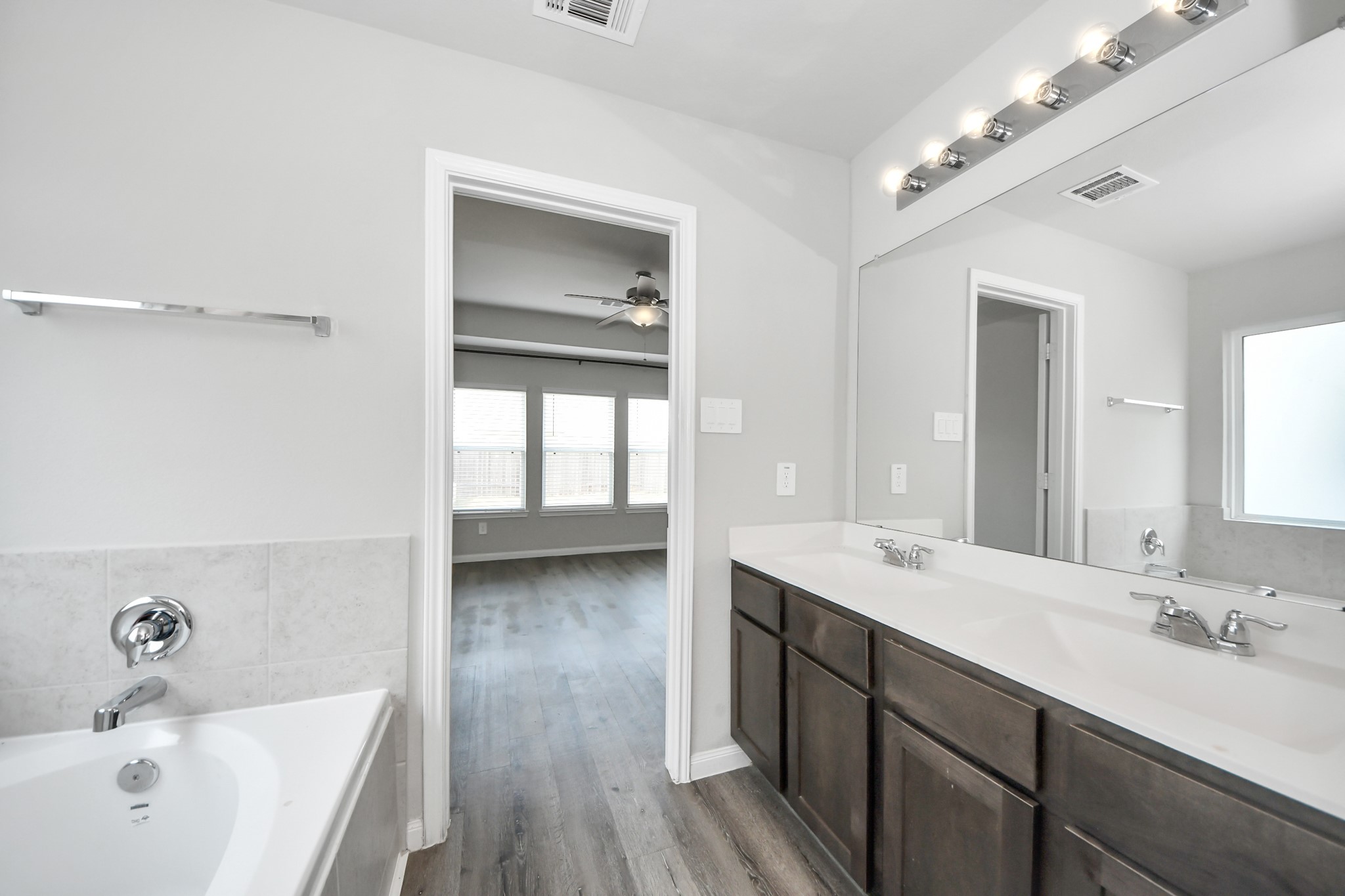 5626 Brooklyn Rose Drive Rosharon, TX 77583 - Photo 22 of 34 a spacious bathroom with a double vanity sink a mirror and a bathtub