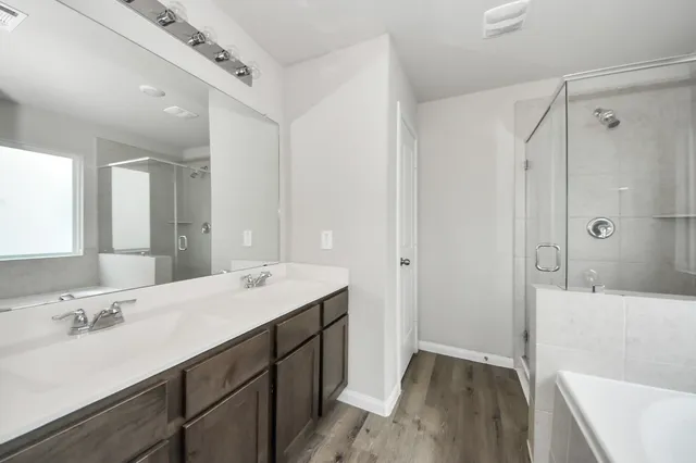 a bathroom with a sink a shower and a mirror